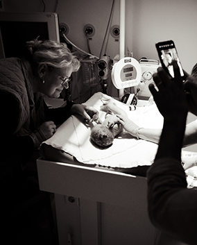 newborn in hospital just after birth with grandparents