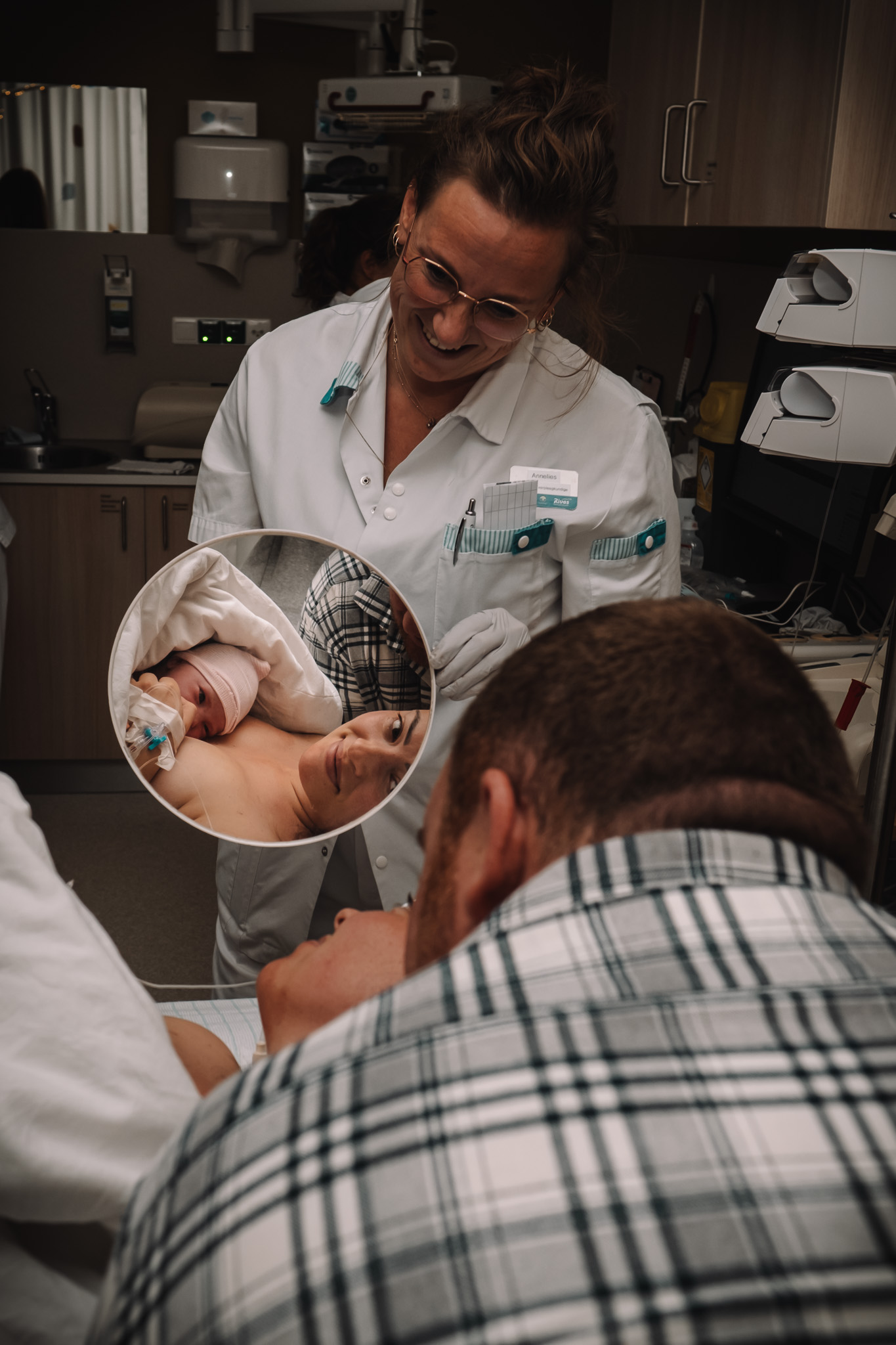 Mother looking at her newborn in mirror