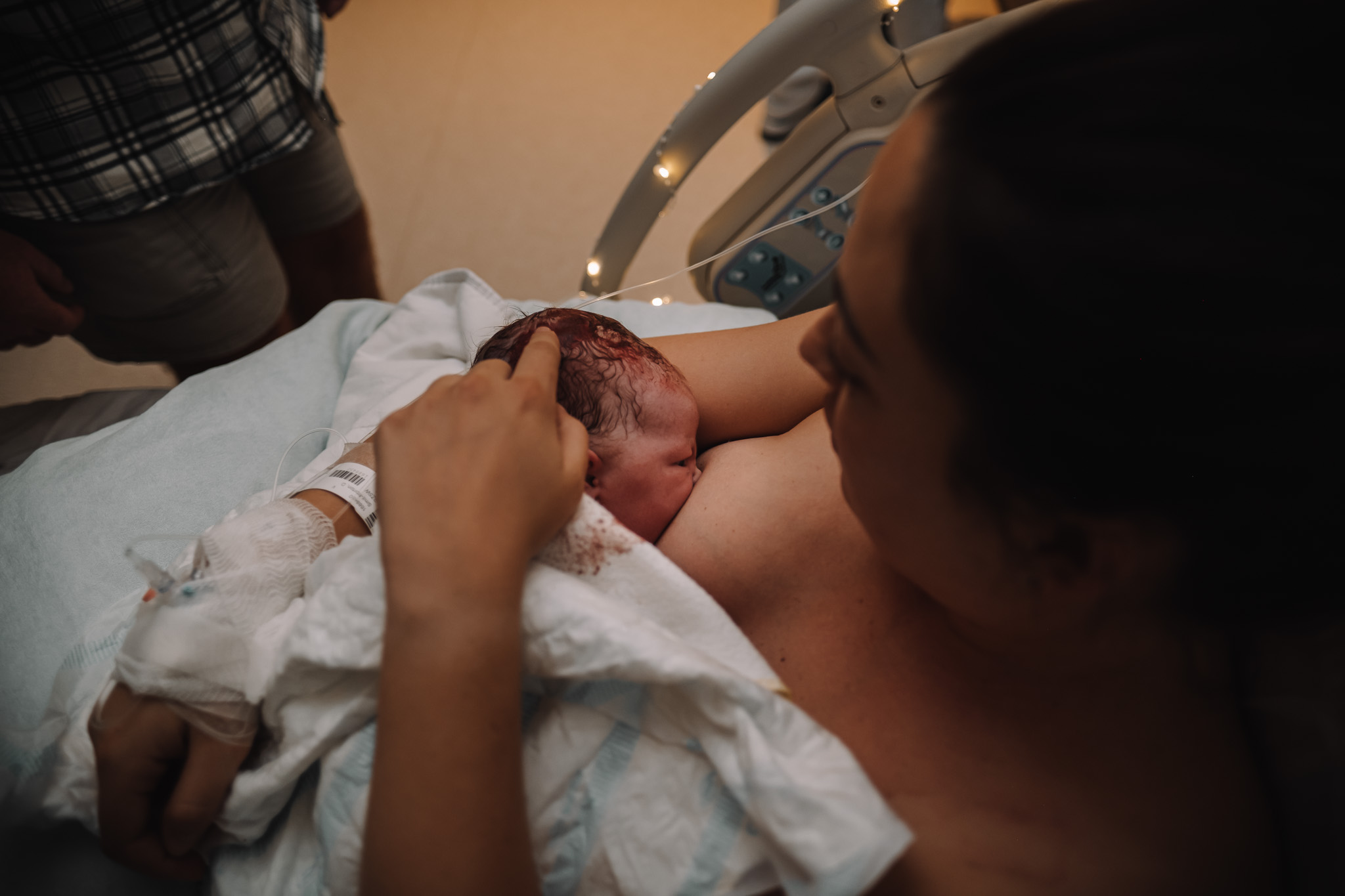 Mother breastfeeding her newborn for the first time.